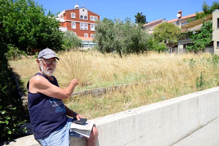 Mario Juravić pokazuje na gradsku parcelu koja se ne kosi, unatoč molbama susjeda (Dejan ŠTIFANIĆ)